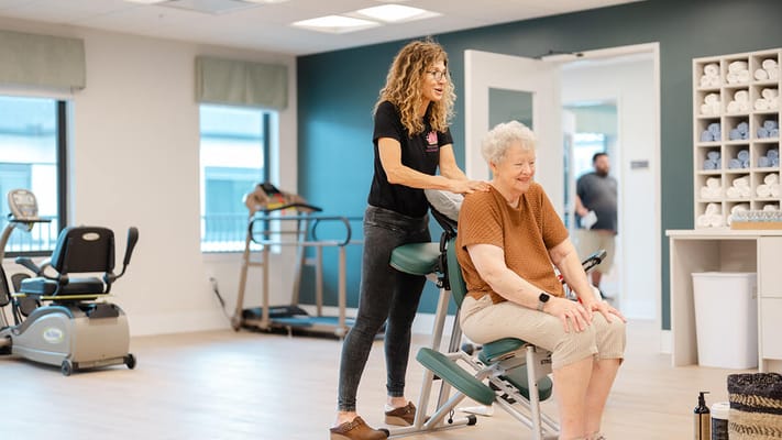 Staff member assisting a resident during a therapy session
