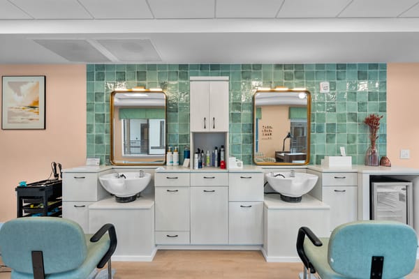 Bright salon area with two hair washing stations
