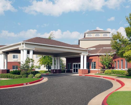 Front entrance of Azalea Estates Assisted Living with a covered driveway