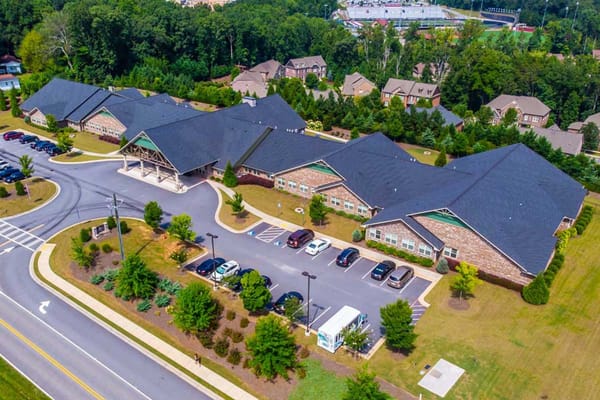 Aerial view of Azalea Estates Assisted Living facility with parking and landscaped grounds.