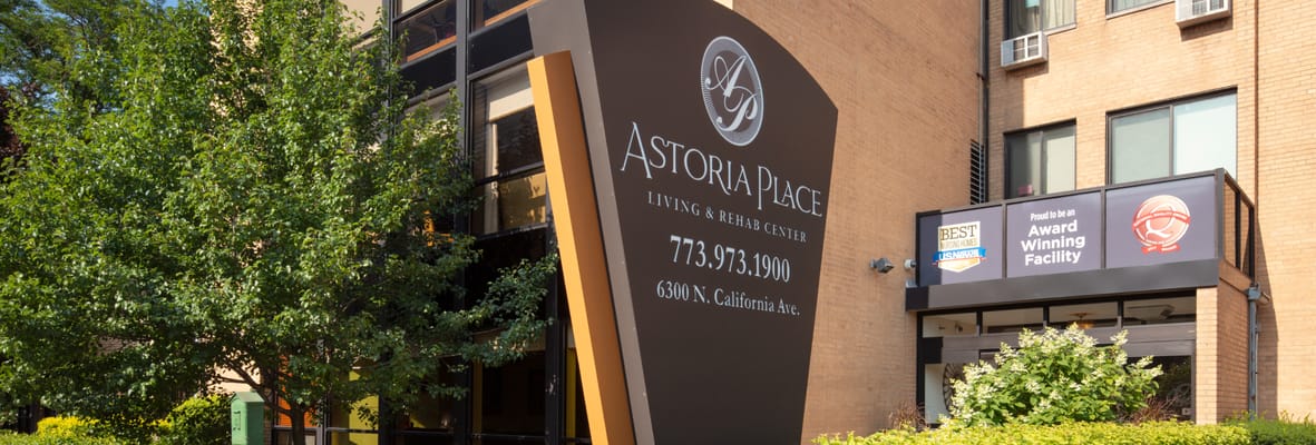 Signage displaying Astoria Place on a sunny day