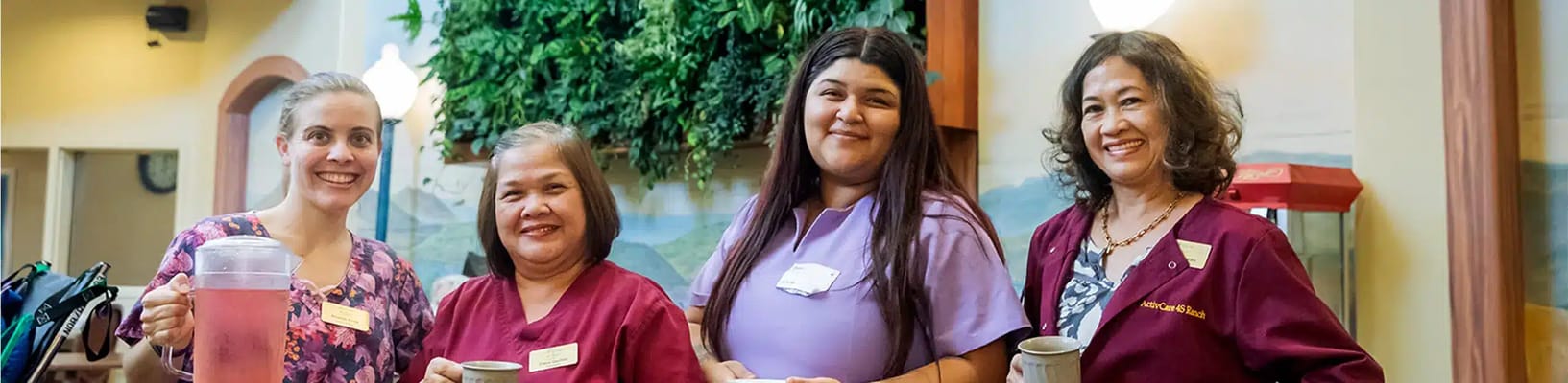 Staff members smiling and posing together indoors