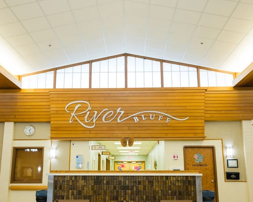 Reception area at River Bluff Nursing Home with wooden decor.