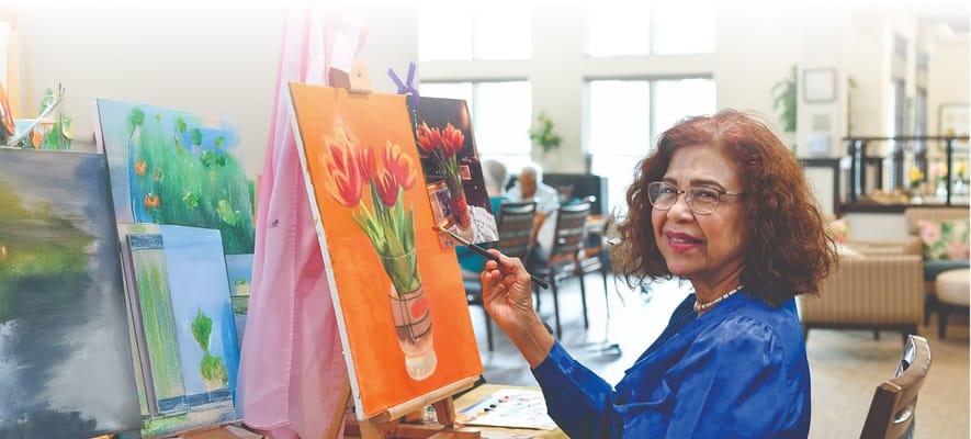 Resident painting in a vibrant common area
