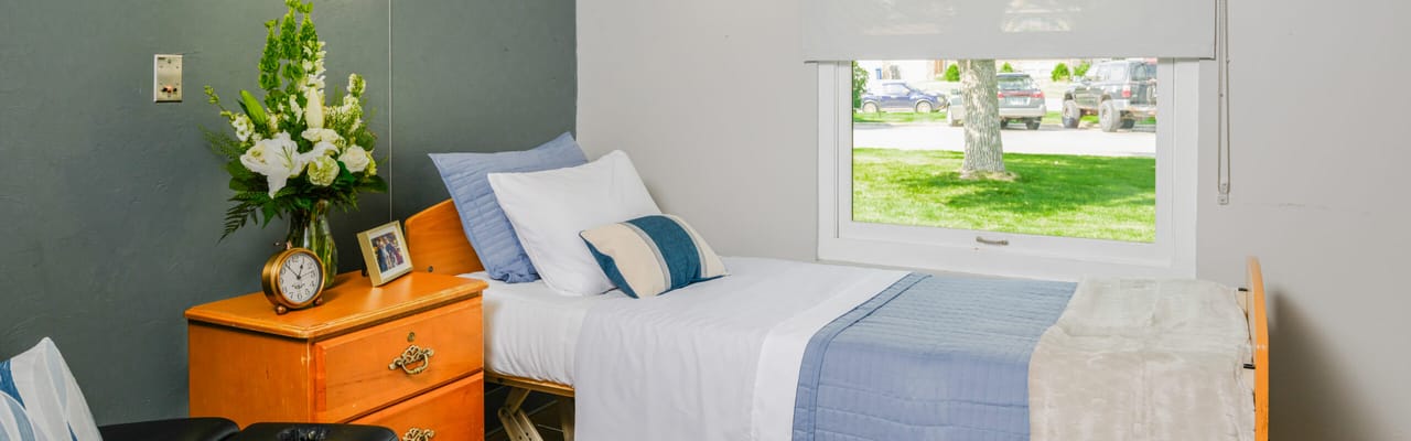 Bright private resident room with bed and decorations