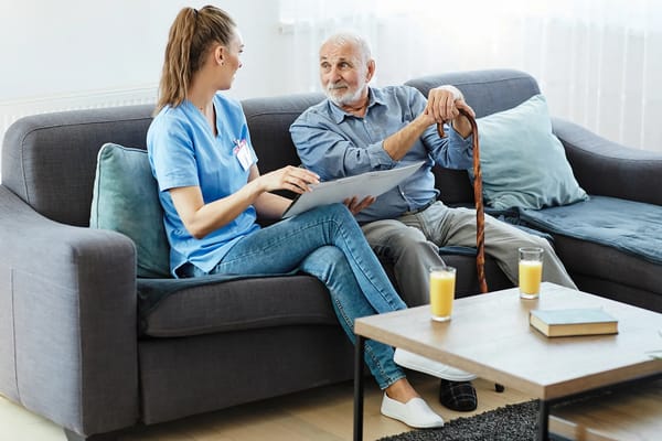 A caregiver interacting with a senior resident indoors