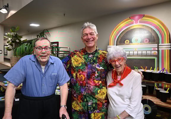 Residents enjoying a colorful gathering with staff