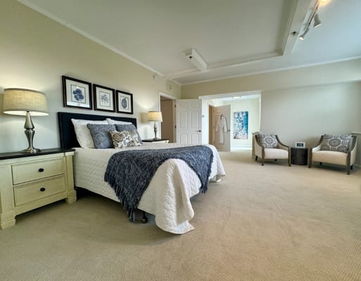 Spacious resident room with a bed and seating area