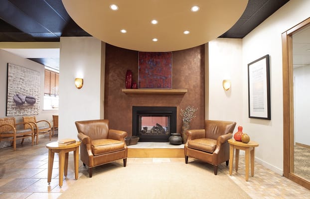 A cozy lounge area with seating and a fireplace