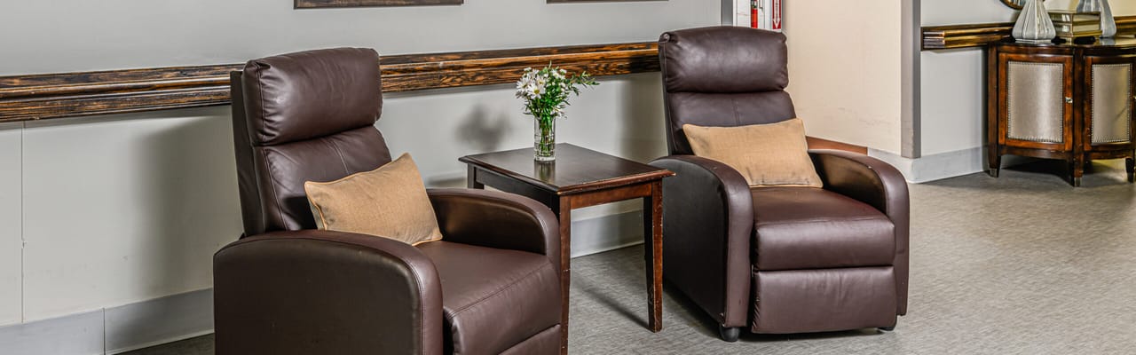 Cozy seating area with two recliners and a table