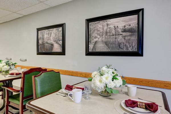 Dining area with floral decor and paintings