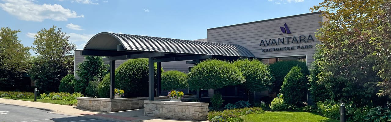 Entrance of Avantara Evergreen Park surrounded by greenery