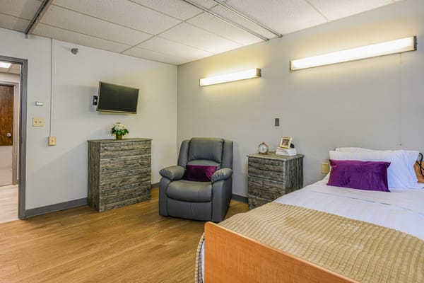 Cozy resident room with a bed and seating area