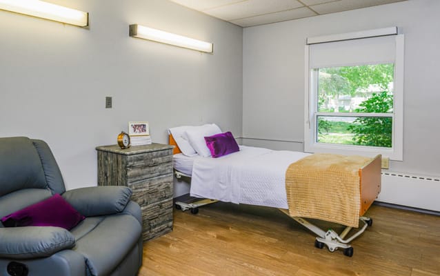 Cozy resident room with a single bed and chair