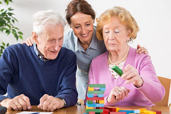 Residents engaging in a game with staff support