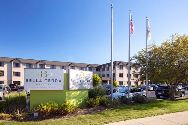 Exterior view of Bella Terra Wheeling with flags and signage
