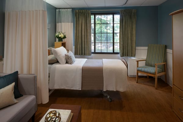 Private resident room with a bed and seating area