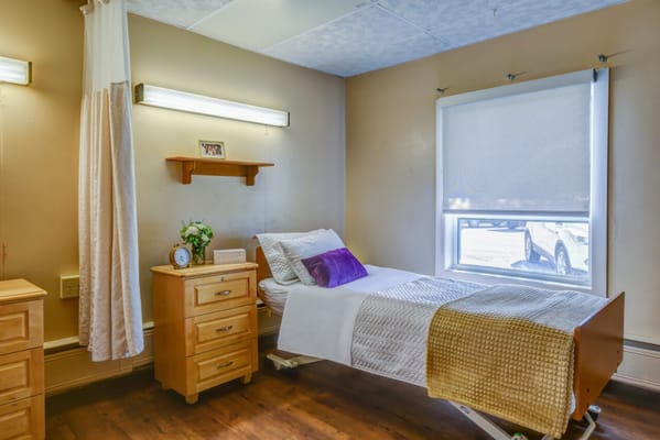 Private resident room with a bed and decor