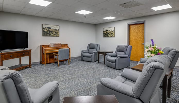 Cozy common area with seating and a piano