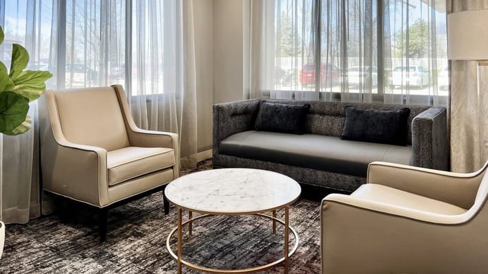 Bright common area with comfortable seating and large windows