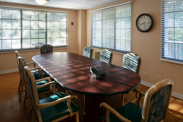 Conference room with a large oval table and chairs