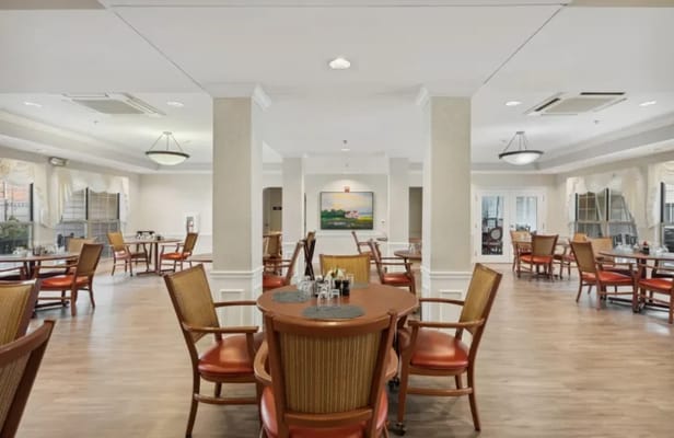 Bright dining area with tables and chairs arranged