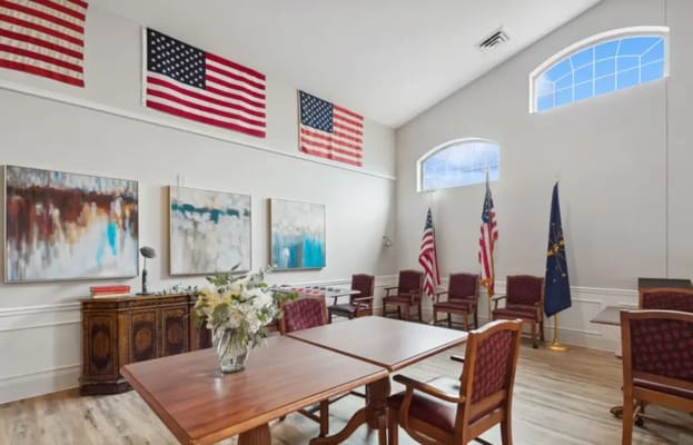 Interior lounge area with chairs and flags