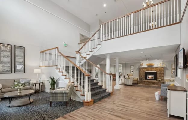 Bright interior common area with a staircase and seating