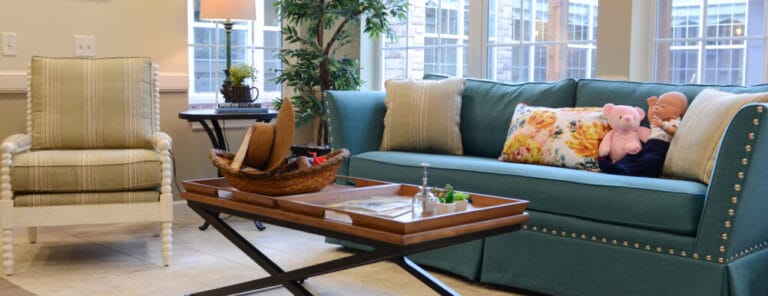 Cozy common area with teal sofa and decorative accents