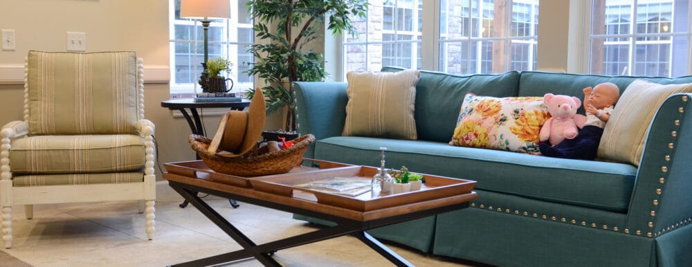 Cozy common area with teal sofa and decorative accents