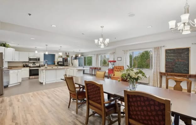 Bright common area with dining table and kitchen access