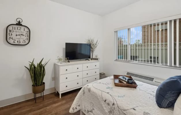 Cozy resident room with a bed and TV
