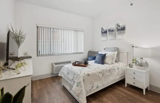 A cozy resident room with a bed and decor