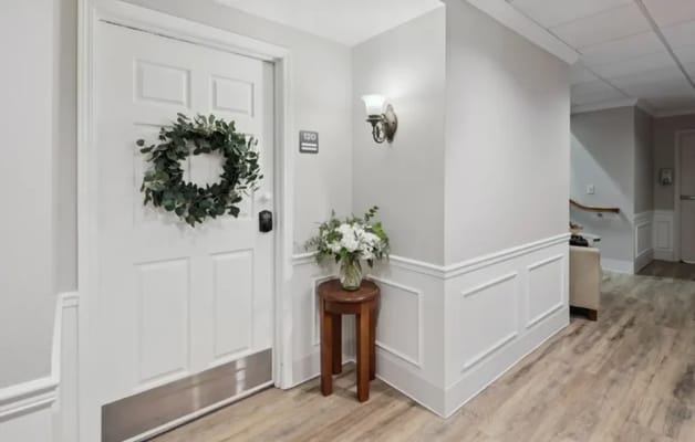 Quiet hallway with a door and wreath decoration