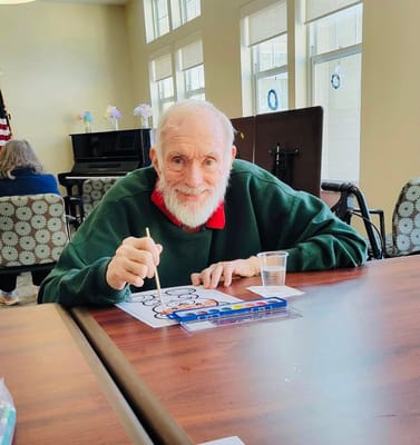 Resident painting in an interior activity room