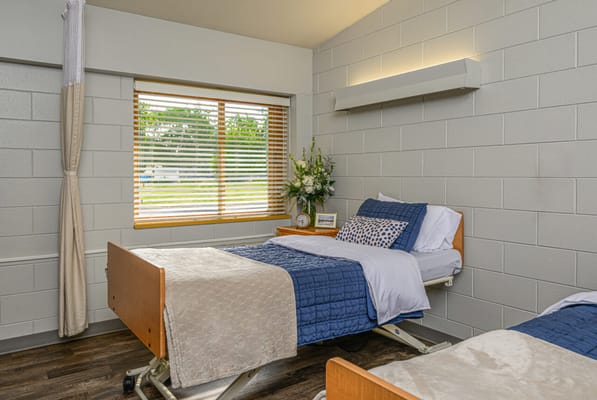 A well-furnished resident room with natural light