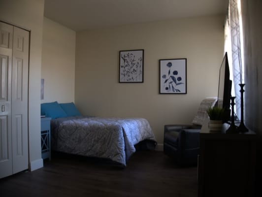 Cozy resident bedroom with light decor and furniture