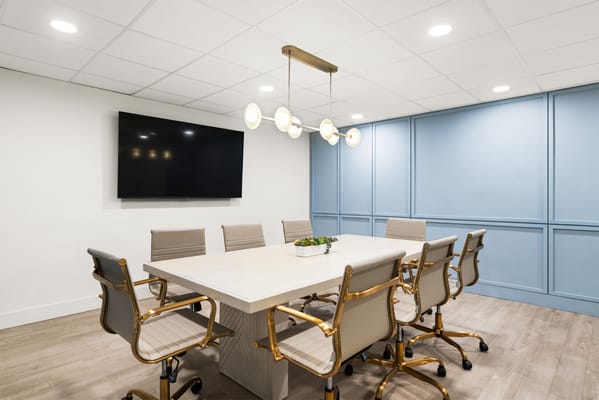 Bright modern meeting room with a large table and chairs