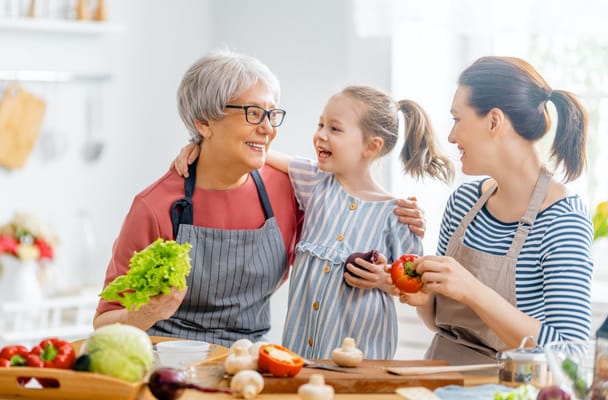 Family cooking together in a bright kitchen