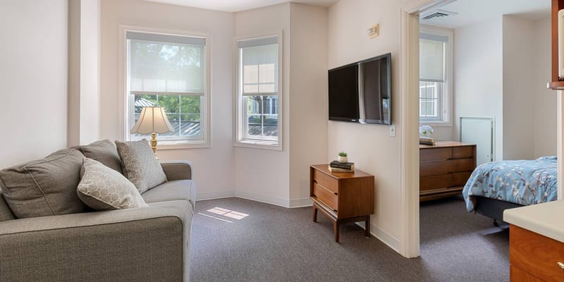 Interior view of a resident room with a couch and dresser