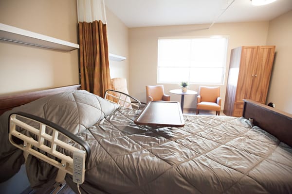 Interior view of a resident's room with hospital bed