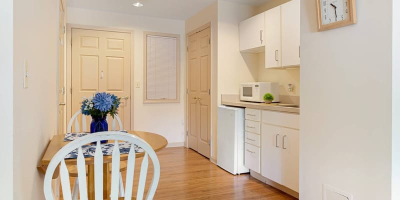 Cozy kitchenette area with a table and flowers