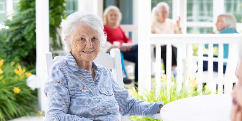 Smiling resident enjoying the outdoor space