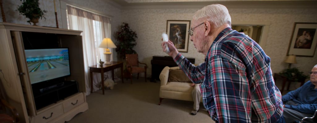 Residents engaged in a Wii bowling game in a common area