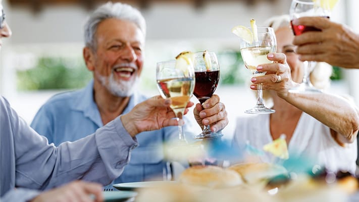 Residents toasting with drinks at an outdoor gathering