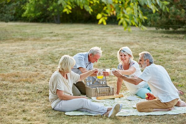 Four residents enjoying a picnic outdoors