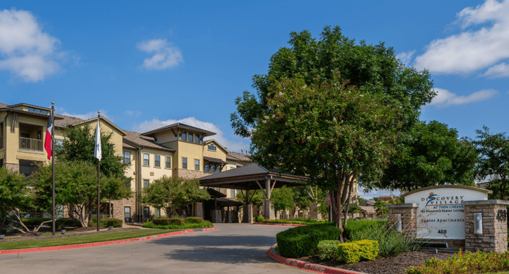 Exterior view of Discovery Village at Twin Creeks with entrance and landscaping