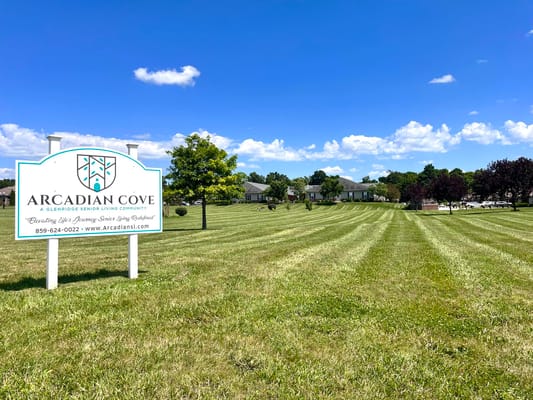 Signage for Arcadian Cove Senior Living at a sunny outdoor area