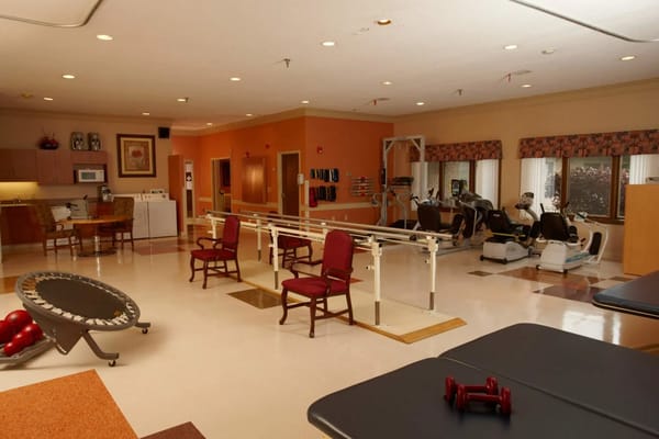 Interior view of the therapy room with equipment and chairs.