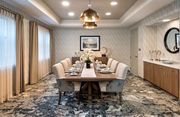Spacious dining room with a large table set for a meal.